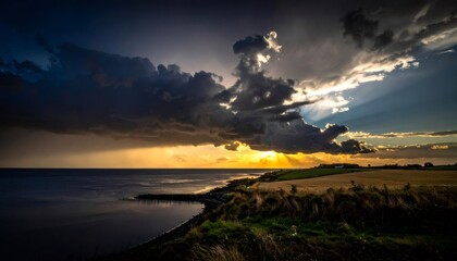 Dramatic sunset over ocean coastline with dark clouds