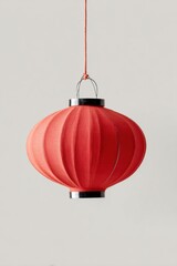 Obraz premium Red paper lantern hanging from a string against a light gray background, showcasing its rounded shape and textured surface, ideal for festive decorations or celebrations