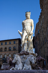 Naklejka premium The Fountain of Neptune in Florence's Piazza della Signoria, in front of the Palazzo Vecchio, is crowned by a majestic marble statue of the god Neptune. Italy