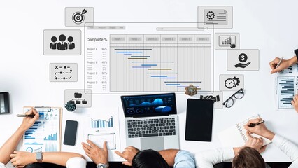 A dynamic workspace scene featuring a laptop, diverse professionals collaborating on project management and data visualization to enhance business strategies and growth. Raster