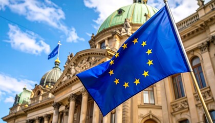 European Union flag with twelve golden stars waving before a classical government building with a dome.