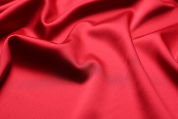 Obraz premium Beautiful red satin fabric as background, closeup view