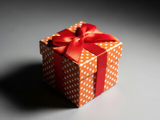 Elegant small gift box with polka dots and red ribbon