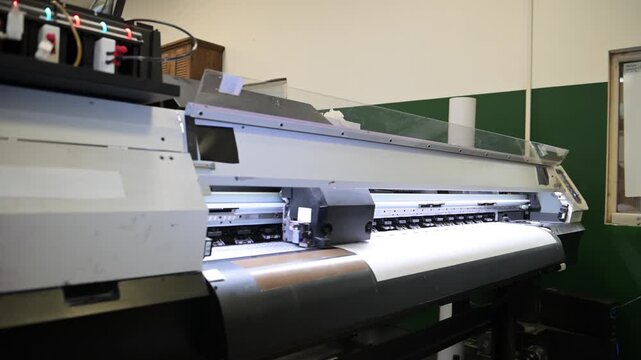 The process of printing a large-format printer in the production workshop of the printing house. Production of printing products