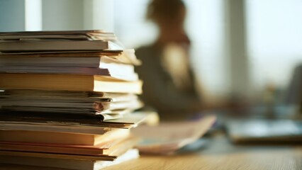 Stacked Books and Documents on Desk