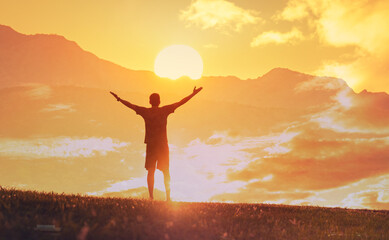 Person Celebrating Freedom at Sunrise, Silhouette of Joy and Success at Golden Sunrise
