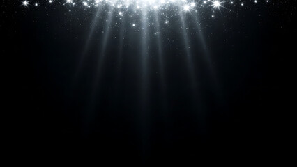 White light beams and sparkling particles falling from above on black background light rays