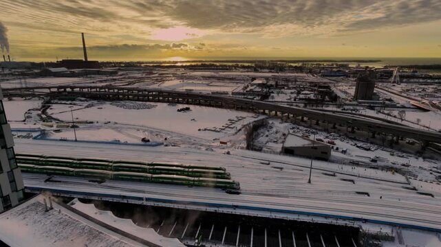 Stunning 4K drone footage of Toronto's iconic skyline at winter sunrise, flying over the Gardiner Expressway bridge amid a pristine snowscape.