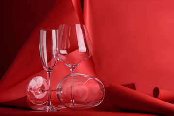 Three Wine Glasses on Sculptural Red Background. Artistic Still Life with Transparency and Form