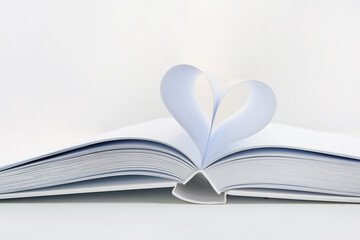 Fototapeta premium Open book showing heart shape with paper pages