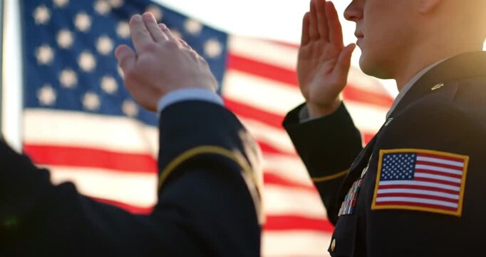 US Soldier Giving Hand Salute with American Flag Patch Visible
