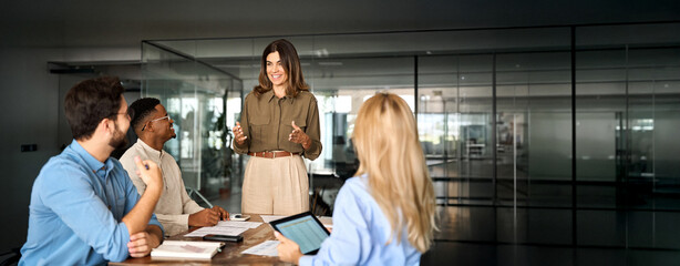 Happy middle aged business woman executive ceo leader discussing project management planning...