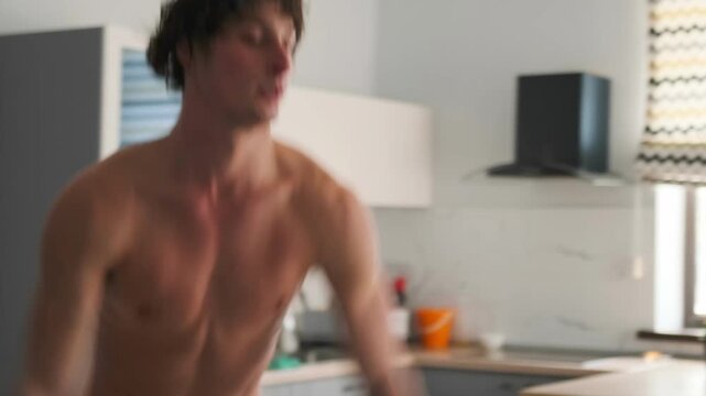 White man exercising, Skilled individual performing rapid jumps during energizing HIIT session, Caucasian man executing explosive jumps in kitchen during intense highperformance training session