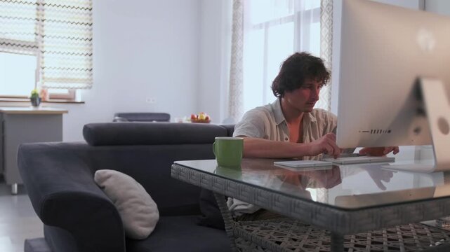 Remote work focus, Dedicated worker focused on digital tasks within comfortable living space, Someone diligently performing online activities while surrounded by warm and inviting home setting