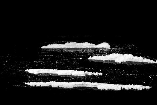 several lines of cocaine isolated on a black background