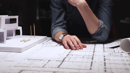 Architects and engineers collaborating on a building project, reviewing blueprints with a compass and divider, developing architectural plans and urban design strategies - Powered by Adobe