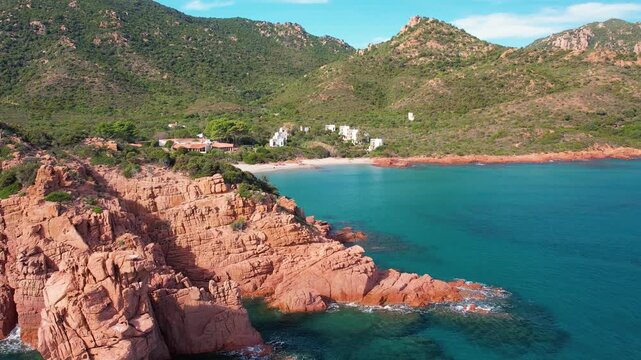 Explore the beautiful Cala E Luas beach in Sardinia from above. The aerial perspective highlights the stunning rocky coastline and sparkling blue waters.
