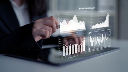A business professional uses a tablet to interpret financial data through interactive holographic charts, showcasing insights and performance metrics in a modern workspace. Impute