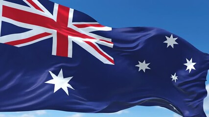 The vibrant Australian national flag proudly flutters and waves gracefully in a gentle breeze against a clear bright blue sky with soft white clouds symbolizing national identity patriotism and the r. - Powered by Adobe