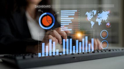 A business professional engages with a digital dashboard showcasing various graphs and charts while working in a modern office environment. Impute
