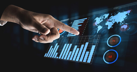 A close-up view of a hand interacting with a sophisticated data visualization interface featuring graphs and global metrics for business analysis. Impute