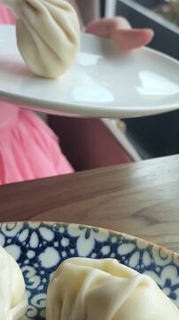 Dumplings blue plate Dumplings gyoza mandu on a blue plate with wooden chopsticks.