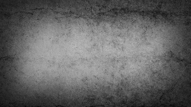 Grunge textured cracked concrete wall in monochrome tones