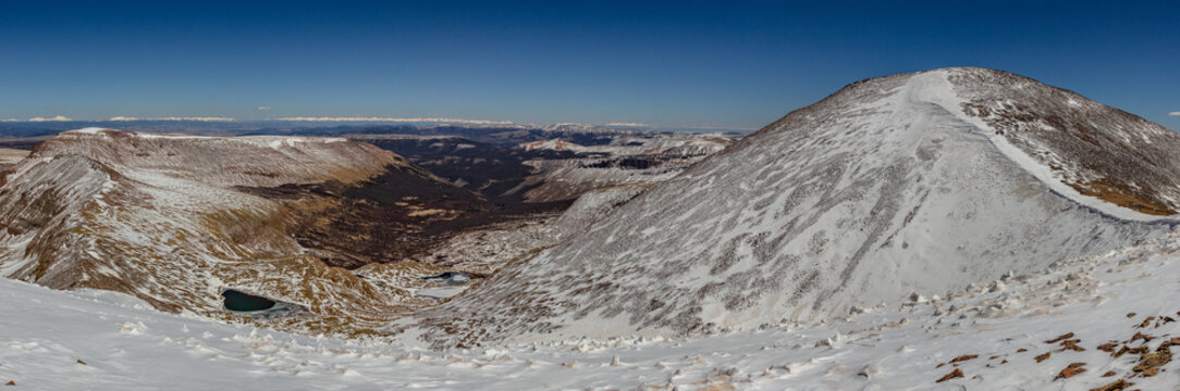 This early-summer mountain panorama features mostly snow-covered 13er, Phoenix Peak, located in the remote La Garita Wilderness of the eastern San Juan Mountains near Creede, Colorado.