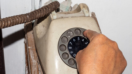 someone is dialing a number on a retro telephone
