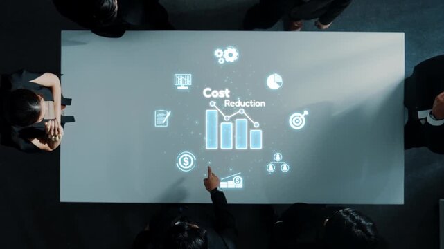 A business team engages in a detailed analysis of cost reduction strategies, with dynamic graphs and icons projected on a sleek conference table. Raster