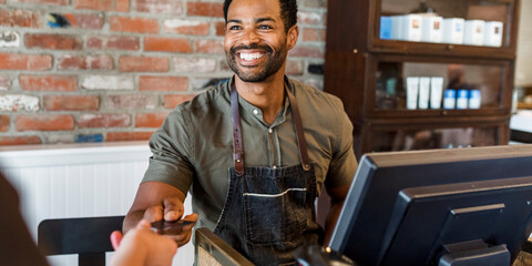 Smiling barista serving customer