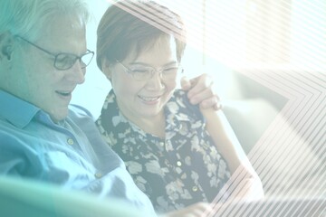 Obraz premium Senior couple using tablet remix