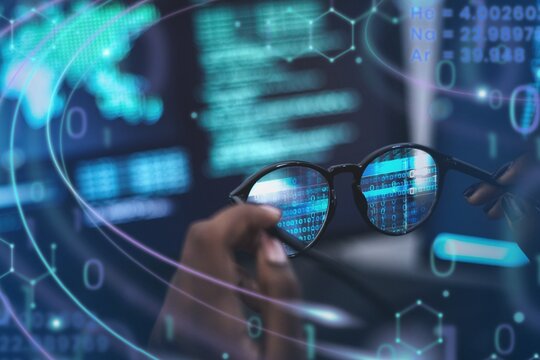 Computer codes reflecting on glasses