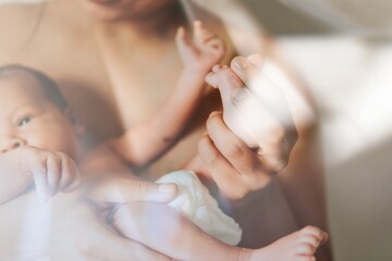 Naklejka premium Mother holding her infant baby