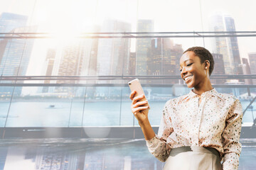 Happy black woman using phone