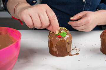A pastry chef finishing the panettone with a marzipan garland.