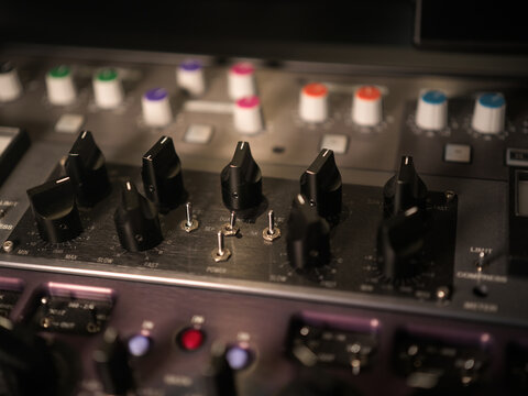 Close-up of an audio mixing console