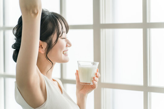 Asian woman drinking milk in the morning at home