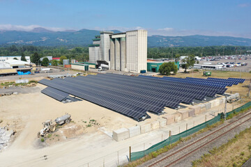 Solar panel installation powering industrial factory building