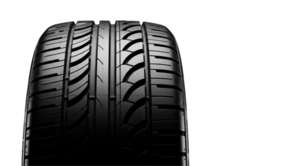 Macro shot of a new high-performance car tire with aggressive tread on a black background with copy space. Concept of automotive performance and precision