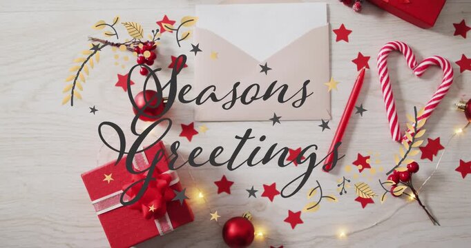 Fairy lights glowing sparking flourishes writing Seasons Greetings on kraft envelope, forming card