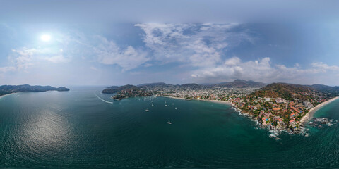 Fototapeta premium 360 Aerial view of Ixtapa Zihuatanejo beach, Costa Grande of Guerrero. Coastal landscape with hotels and crystal clear sea. Zihuatanejo, Guerrero, Mexico.