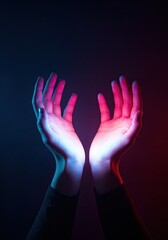 Obraz premium Embracing Radiance: Hands outstretched in a gesture of welcome or offering, bathed in a captivating interplay of red and blue light. Symbolizing connection, hope, or even a sense of wonder. 