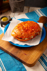 Pambazos. Mexican sandwich marinated in red sauce and roasted on a comal traditionally stuffed with potatoes and chorizo, a classic of Mexico City street food.