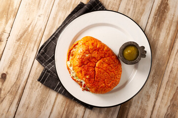 Pambazos. Mexican sandwich marinated in red sauce and roasted on a comal traditionally stuffed with potatoes and chorizo, a classic of Mexico City street food.