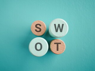 Wooden blocks with symbol SWOT. SWOT analysis, transforming weakness into strengths with strategic business planning. Ideal for business strategy, planning, and decision-making visuals.