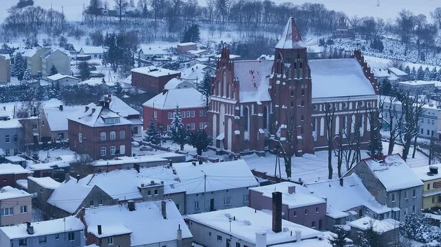 Aerial winter Teutonic Gothic church Radzyn Poland slide. Brick Gothic monastery castle built 1234 AD, Teutonic Knights. Northern royal town.  Historical buildings. Saint Anne church 12th century.