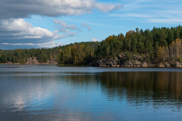 Small rocky islands in narrow bays in the Ladoga Skerries National Park, near the village of Lumivaara, on a sunny autumn day, Republic of Karelia, Russia
