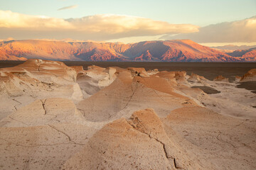Fototapeta premium Pumice Stone Field Landscape with Mountains at Sunset in Catamarca, Argentina
