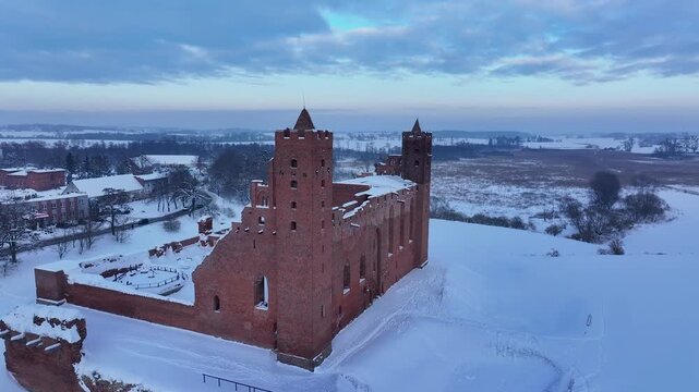 Aerial winter Teutonic Castle Radzyn Poland fly over. Brick Gothic monastery castle built 1234 AD, Teutonic Knights. Northern royal town.  Historical buildings. Saint Anne church 12th century.